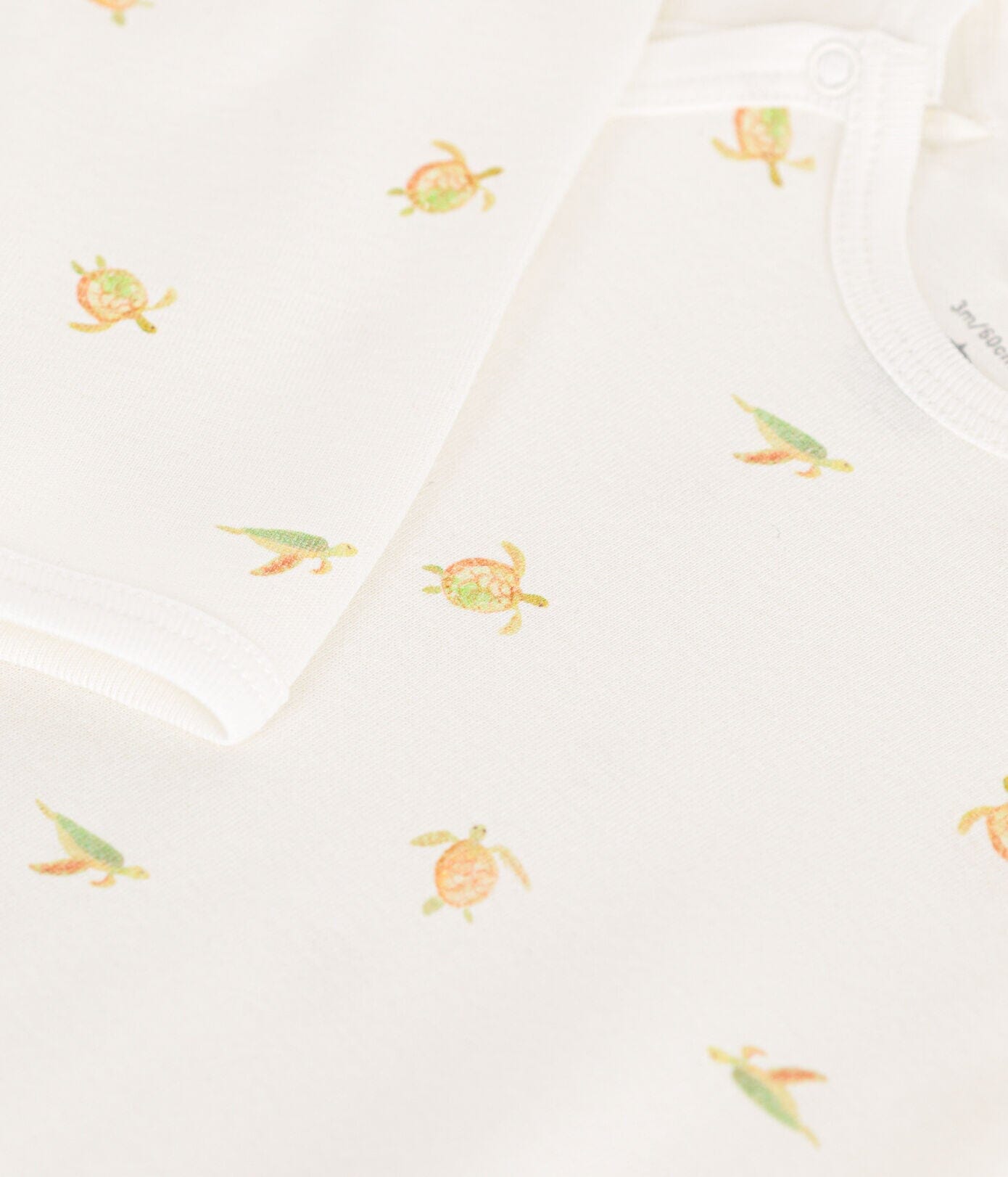 Petit Bateau cremefarbener Strampler mit Schildkröten Strampler Petit Bateau